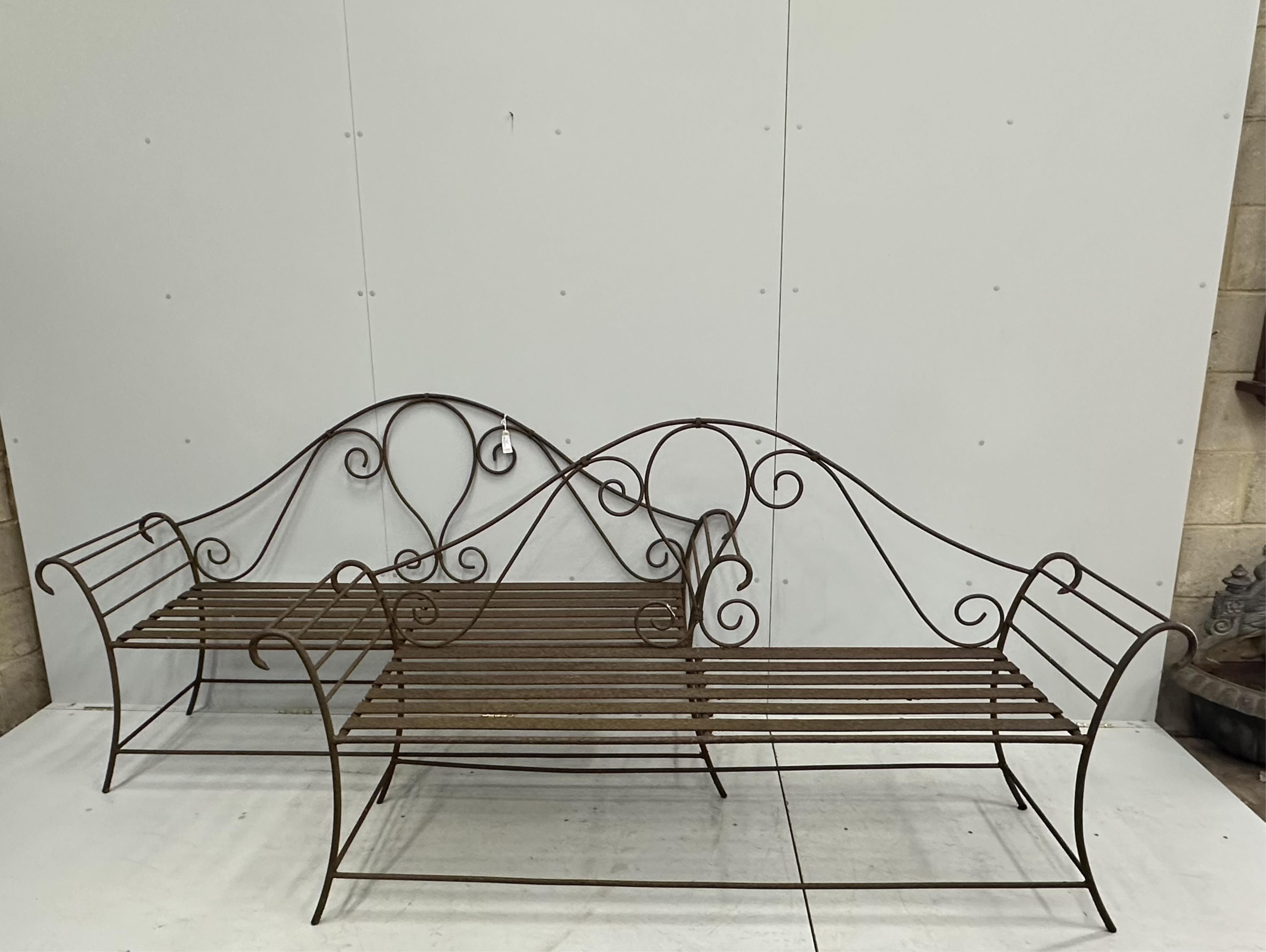 A pair of wrought iron garden benches, width 184cm, height 102cm. Condition - fair